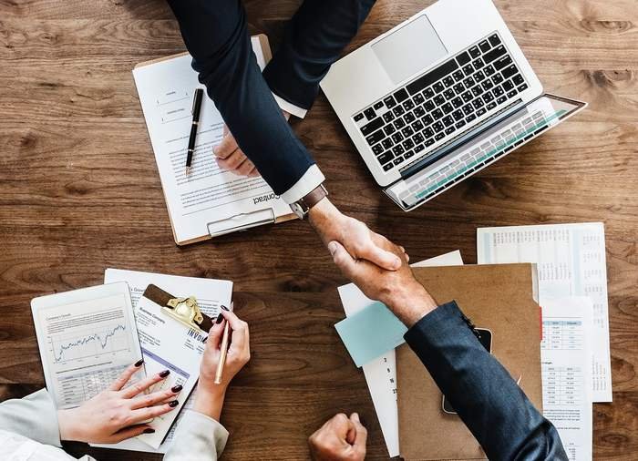 Personas reunidas alrededor de una mesa de trabajo